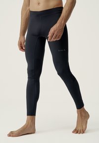 Námořnické sportovní legíny vyrobené z elastické tkaniny, s hladkou texturou, přiléhavým střihem a minimálními švy.