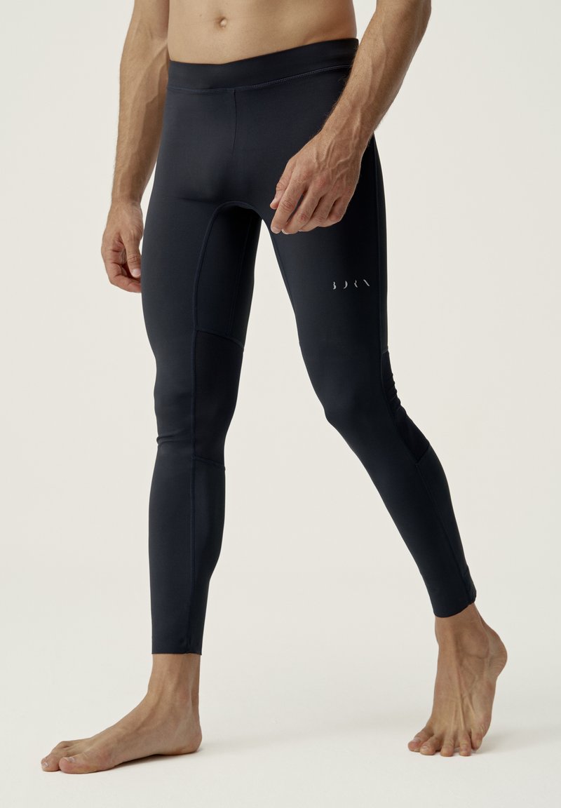 Námořnické sportovní legíny vyrobené z elastické tkaniny, s hladkou texturou, přiléhavým střihem a minimálními švy.