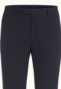 Navy blue textured trousers featuring a flat front, belt loops, and a smooth waistband. The fabric exhibits a subtle pattern.