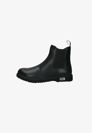Botte Chelsea en cuir noir avec panneaux latéraux élastiques, languette de tirage au talon, semelle à faible relief et logo de la marque en métal près de la semelle.