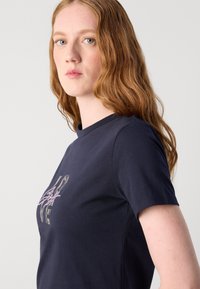Navy blue cotton T-shirt with short sleeves, featuring a graphic design with "LOVE" in metallic and pink accents on the front.