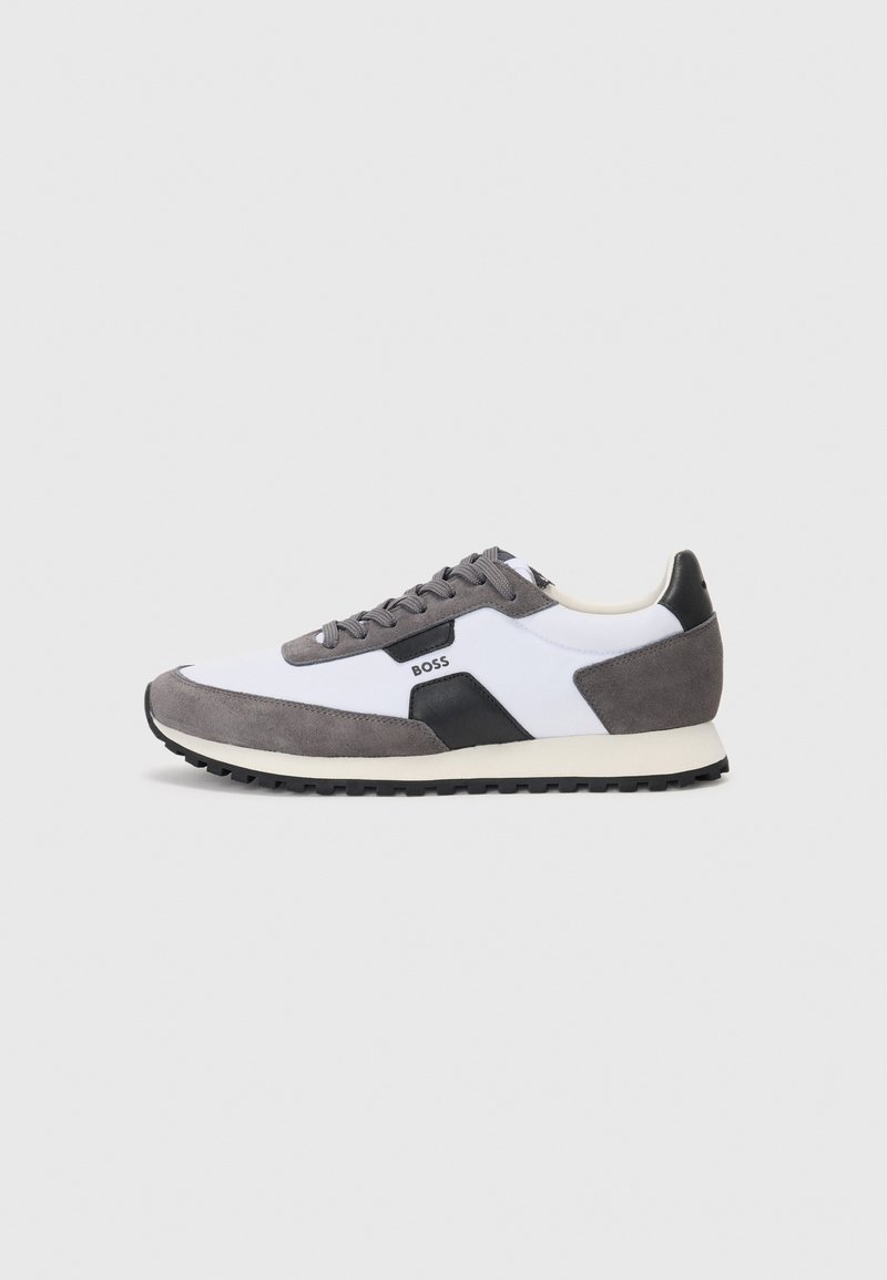Gray and white sneakers with a suede and synthetic material blend. Features black accents, round laces, and a textured black rubber sole.