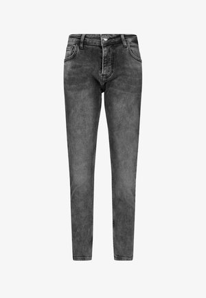 Mustadest denimist valmistatud kitsad teksad, millel on sile tekstuur, viie taskuga disain, vöökohal kinnitamiseks taskud ja ühe nupuga kinnitamine.