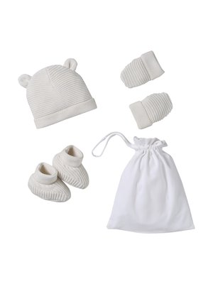 White knitted baby hat with bear ears, mittens, booties, and a white drawstring storage pouch on a white background.