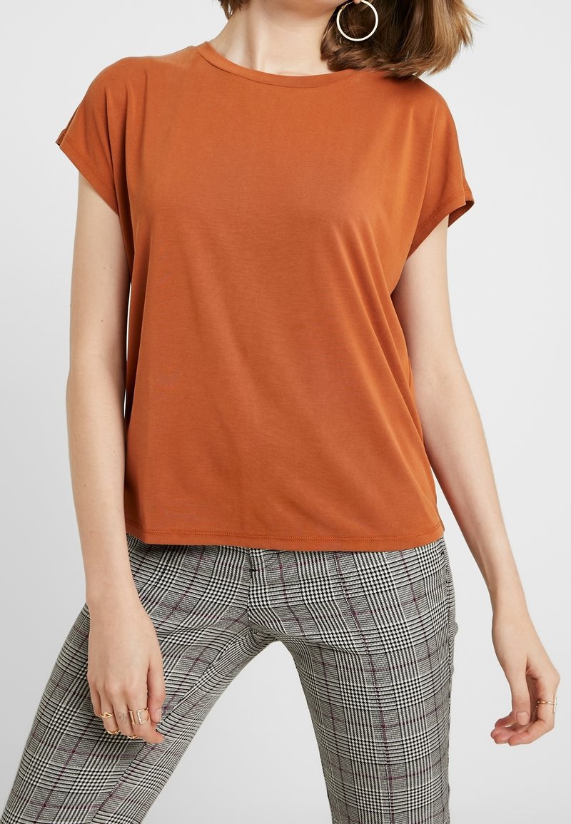 Brown short-sleeve t-shirt with a round neck, smooth texture, worn with gray plaid pants. Features a loose fit and hemmed edges.