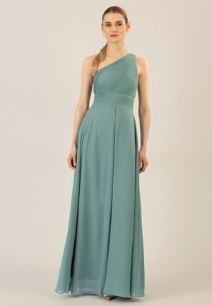 One-shoulder teal gown made of flowing, smooth fabric with pleated texture at the bodice and a gathered waist, extending to a full skirt.