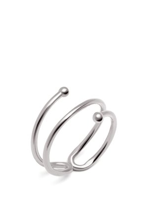 Anneau en métal argenté ajustable ouvert aux extrémités avec deux boules rondes, design en spirale, sur fond blanc.