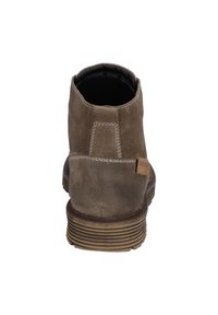 Brown suede ankle boot with a rounded toe, contrast stitching, and a textured rubber sole. Features a small logo tag on the heel.