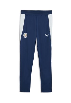 Marineblå sportstrusser med lysegrå sidepaneler, Manchester City-logo på venstre lår og hvid Puma-logo på højre lår.