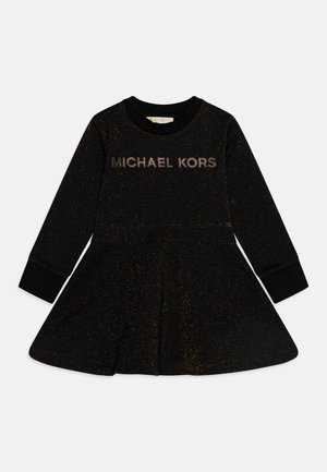 Robe noire pailletée à manches longues avec jupe évasée et logo doré "MICHAEL KORS" sur la poitrine.