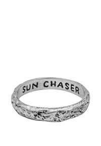 Ezüst gyűrű texturált felülettel és a "SUN CHASER" gravírozással a belsején, enyhén egyenetlen, organikus kialakítással.