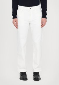 White cotton jeans with a straight-leg design and standard five-pocket style. Features a metal button and zipper closure.