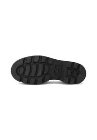 Black rubber shoe sole with pronounced tread pattern, curved shape, and textured finish. Features logo detail on midsole area.