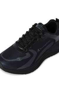 Black athletic shoe with a textured upper, sleek design, and tonal gray accents. Features black laces and logo detailing on the side.