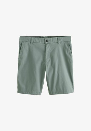 Rohelised põlveni ulatuvad vabaajarõivaste lühikesed püksid vööaugudega, esikinnis nupuga, tõmblukuga ja küljetaskutega valgel taustal.