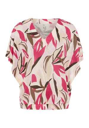 Blouse à encolure en V à coupe ample avec manches courtes, présentant une base beige et des motifs abstraits audacieux en formes de feuilles roses et brunes.