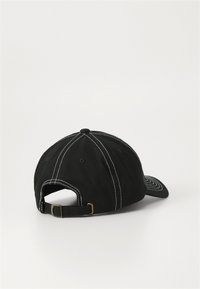 Black baseball cap made of cotton with white stitching. Features a curved brim and adjustable strap at the back. Classic six-panel design.