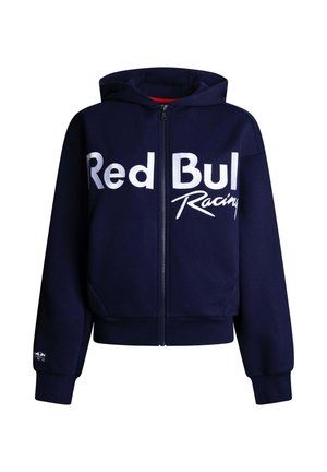 Tmavomodrá mikina na zips s bielym nápisom „Red Bull Racing“ na prednej strane a malým logom na manžete ľavého rukáva.