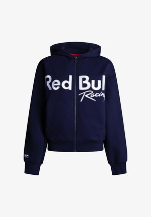 Tmavomodrá mikina na zips s bielym nápisom „Red Bull Racing“ na prednej strane a malým logom na manžete ľavého rukáva.