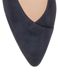 Navy suede pointed-toe shoe with a smooth texture and a sleek, modern design. Features a subtle cutout along the upper edge.