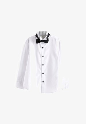 Chemise blanche à manches longues, avec des boutons noirs et un nœud papillon noir. Présente un col intérieur à motif. Texture plate et lisse.