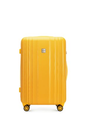 Yellow hard-shell suitcase with a textured surface, vertical grooves, a sturdy handle, and four rotating wheels for easy mobility.