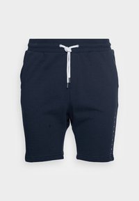 Shorts en coton bleu marine avec une taille élastique, un cordon blanc, des poches latérales et un logo imprimé verticalement sur une jambe.