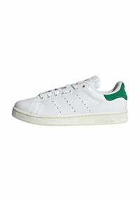 Białe skórzane sneakersy z zielonymi akcentami, okrągły czubek, perforowane boki i płaska, kremowa podeszwa. Posiadają sześć oczek i minimalne oznakowanie.