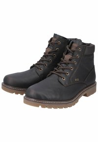 Botas de tobillo de cuero negro con acabado texturizado, detalles en marrón, diseño de cordones y suelas de goma resistentes para una buena tracción. Incluye un detalle de cremallera lateral.