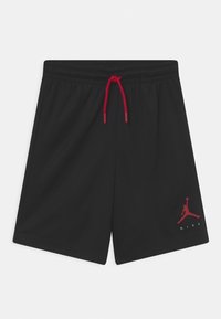 Černé sportovní šortky s červeným stahovacím šňůrkou a červeným logem Nike Air Jordan na dolní levé noze, elastický pas a boční kapsy.