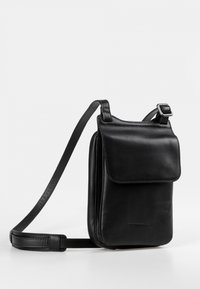 Borsa a tracolla nera in pelle con chiusura a patta, tracolla regolabile e texture liscia. Presenta un design minimale e un branding discreto.