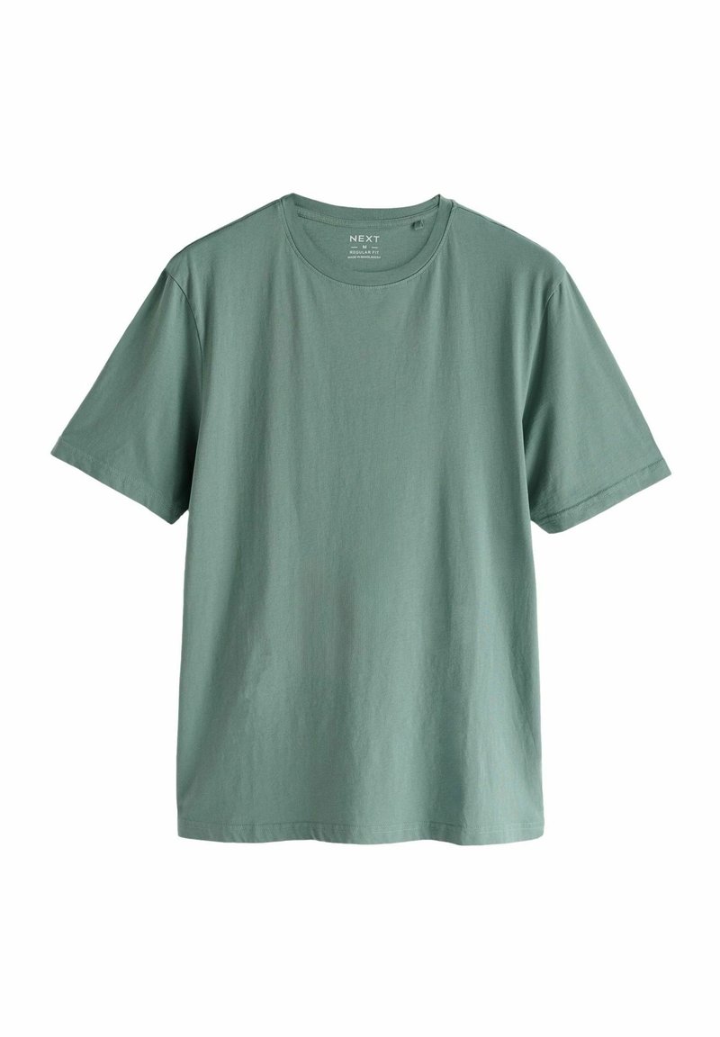 Camiseta de manga corta verde claro, hecha de algodón suave, con un escote redondo y un corte holgado, sin patrones ni gráficos visibles.