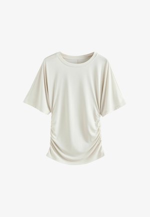 Haut beige clair à manches courtes avec un col rond et un détail froncé sur le côté, confectionné dans un tissu doux et lisse. Mets en valeur une coupe décontractée.