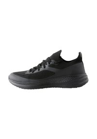 Black athletic shoe with a mesh upper, cushioned sole, and textured accents. Features slim lacing and a pull tab at the heel.