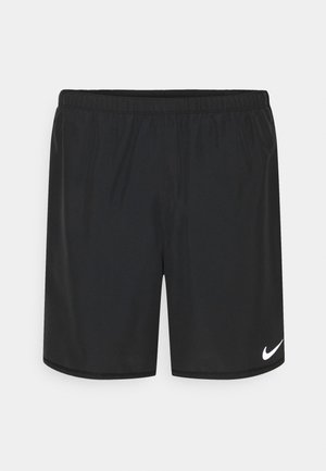 Schwarze Sportshorts mit elastischem Bund und weißem Nike-Swoosh-Logo am unteren rechten Bein vor schlichtem Hintergrund.