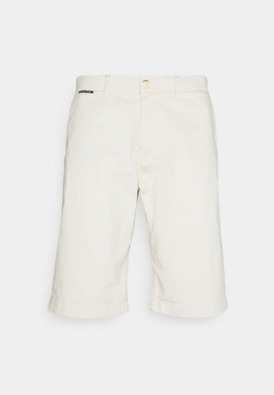 Beige katoenen shorts met een rechte snit, opgerolde zoom en een enkel decoratief label bij de tailleband. Voorzien van knoopsluiting en zakken.
