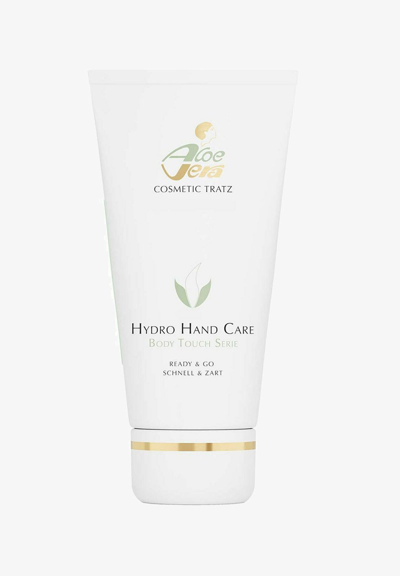 White plastic tube with gold accents, labeled "Hydro Hand Care." Features green leaf logo and text in black, indicating quick-absorbing hand cream.