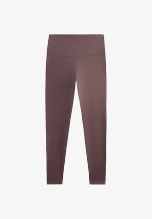 Bruna, figurnära leggings gjorda av elastisk tyg; mellan hög midja; slät textur utan mönster eller accenter.