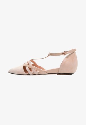 Pink suede flat shoe with pointed toe, T-strap design, and ankle strap. Soft texture and minimalistic style with a low heel.