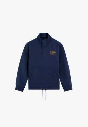 Navy pullover sweatshirt with a high collar, front kangaroo pocket, and drawstring hem. Features a gold logo on the chest. Cotton blend fabric.