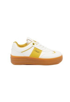 White sneakers with yellow accents and a textured rubber sole. Features a cushioned collar and a prominent logo on the side.