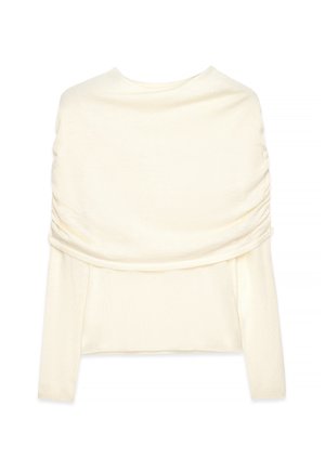 Kremkrāsas pailga piedurkņu blūze ar plašu sakrautu dekoltē, kas plūst pāri pleciem, izgatavota no mīksta adīta auduma.