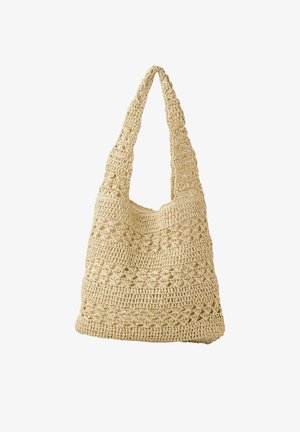 Sac à bandoulière beige crocheté avec large sangle et motifs floraux en maille ouverte, structure souple et style décontracté.