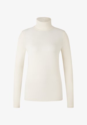 Top à manches longues en crème, en tissu lisse. Design ajusté avec un col montant et une construction sans couture.