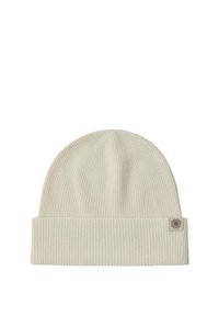 Krämfärgad ribbad stickad mössa med vikbar kant och en liten brun logotagg på sidan. Mjuk textur och tajt passform.