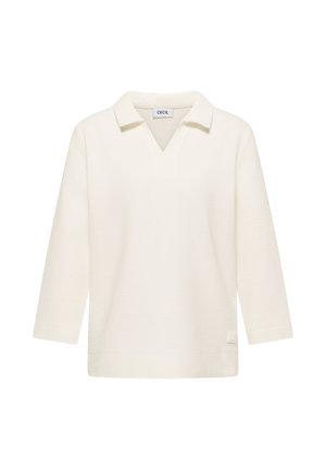 Haut en maille côtelée crème à manches longues avec col en V et coupe décontractée, présentant un petit patch logo rectangulaire près de l'ourlet.