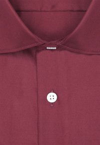 Camicia bordeaux con colletto classico, texture liscia, chiusura frontale con bottoni a quattro fori bianchi e dettagli di cucitura curati.