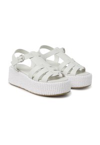 Sandali platform bianchi con suole in corda intrecciata. Presentano fasce incrociate in materiale morbido e una fibbia alla caviglia regolabile.