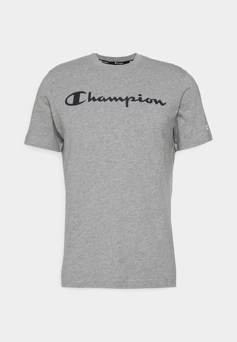 T-shirt gris à manches courtes en coton avec le logo noir "Champion" sur la poitrine et un petit logo sur la manche gauche.