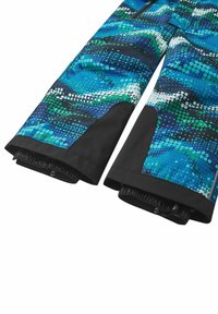 Waterproof pants in blue and green wave pattern, featuring black accents, elastic cuffs, and zippered pockets for secure storage.